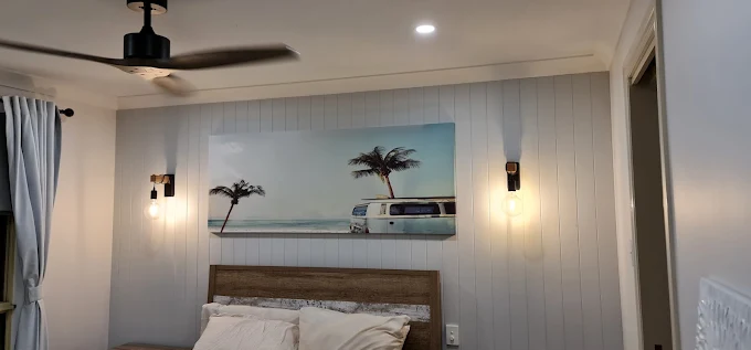 Bedroom with new wall lights, downlights and a ceiling fan
