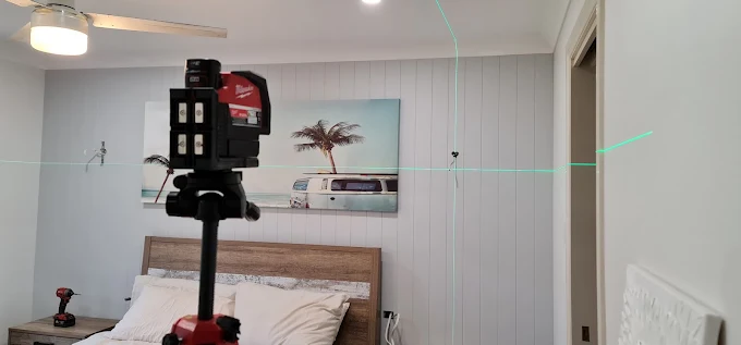 Laser level setting out light positions in a bedroom