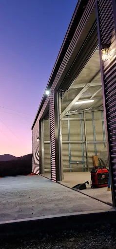 New shed with outdoor and interior lighting at dusk